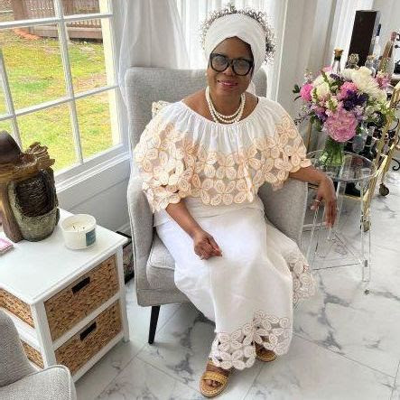 Barbara Perkins sitting in chair wearing white dress | IBWPPI